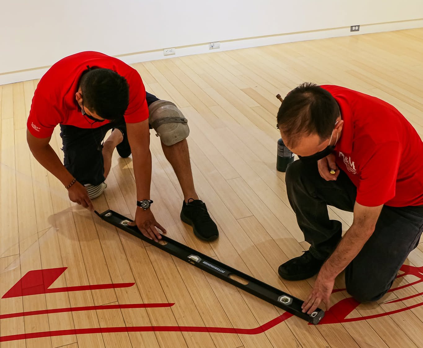 A&M Graphics crew wearing custom embroidered team shirts on an install