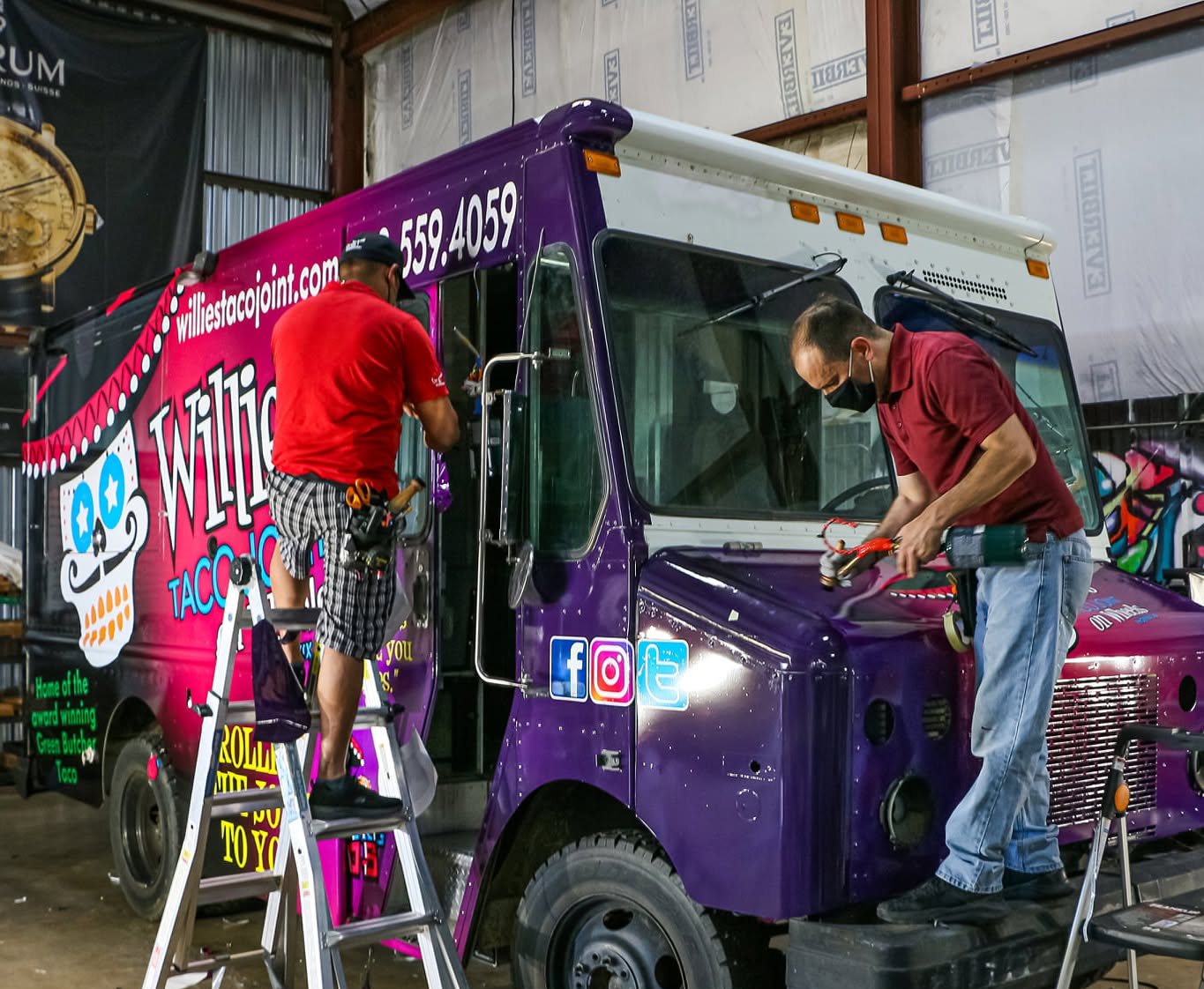 A&M Graphics installer applying vinyl to a truck panel in Arizona
