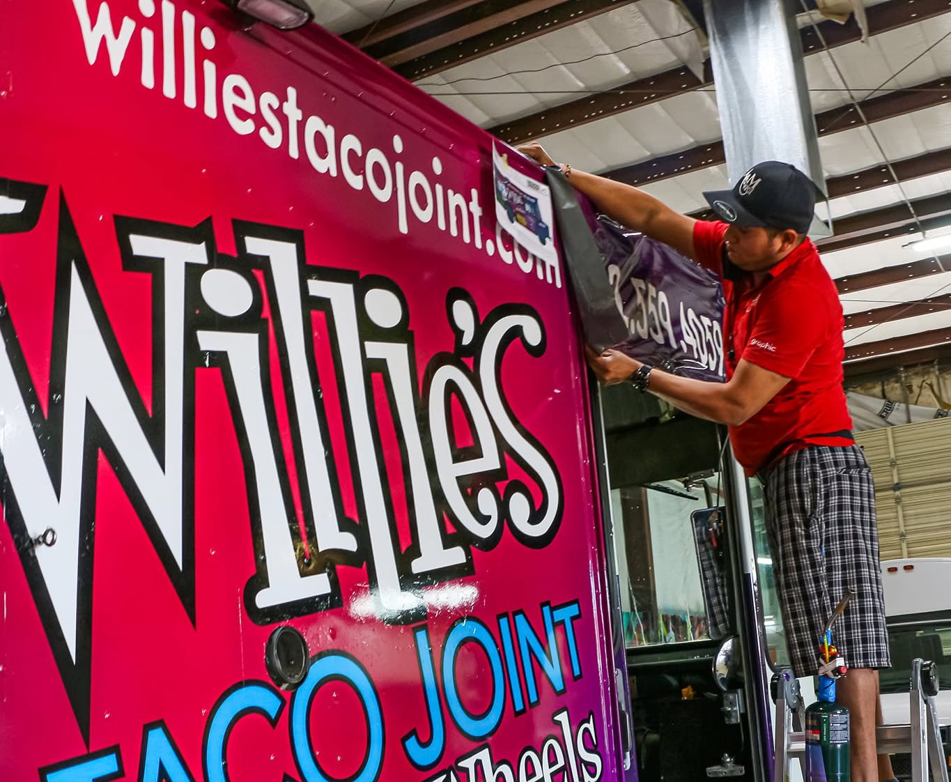A&M Graphics installers fitting vinyl graphics to a truck in Mesa, Arizona